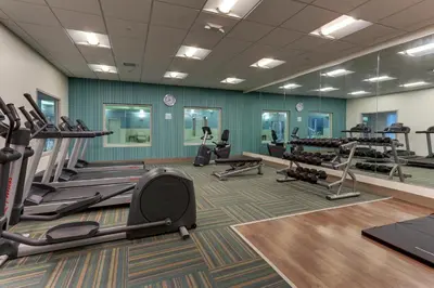 a gym with several treadmills and exercise machines at Holiday Inn Express & Suites - Saugerties - Hudson Valley by IHG in Saugerties