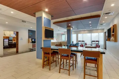 an office lobby with a table and chairs at Holiday Inn Express & Suites - Saugerties - Hudson Valley by IHG in Saugerties