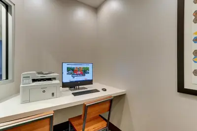 a computer sitting on a desk with a printer at Holiday Inn Express & Suites - Saugerties - Hudson Valley by IHG in Saugerties