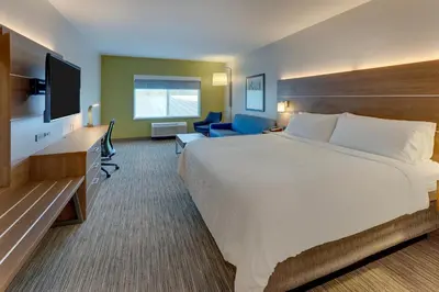 a hotel room with a large bed and a television at Holiday Inn Express & Suites - Saugerties - Hudson Valley by IHG in Saugerties