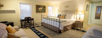 a bedroom with a bed and a desk in a room at Cooper Hill Inn in West Dover