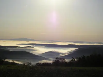 a view of a foggy valley with the sun in the background at Cooper Hill Inn in West Dover