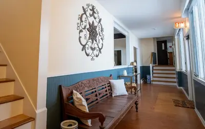 a hallway with a wooden bench in a house at Cooper Hill Inn in West Dover