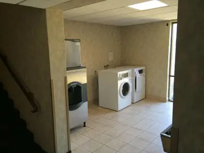 a laundry room with a washer and dryer at Travelodge by Wyndham Vernon CT in Vernon