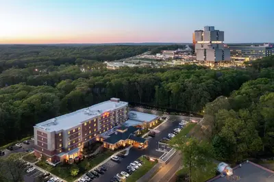 an overhead view of a building with a parking lot at Hilton Garden Inn Stony Brook in Stony Brook