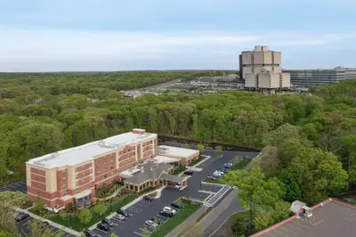 an aerial view of a building with a parking lot at Hilton Garden Inn Stony Brook in Stony Brook
