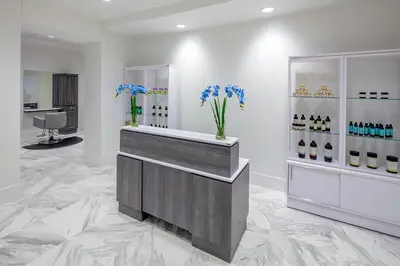 a lobby with a counter with vases of flowers at YO1 Longevity & Health Resorts, Catskills in Monticello