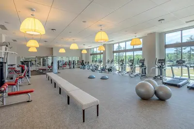 a gym with a bench and many exercise equipment at YO1 Longevity & Health Resorts, Catskills in Monticello