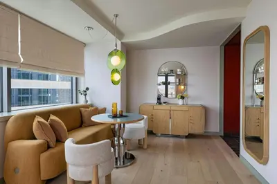 a living room with a couch and a table at W Hoboken in Hoboken