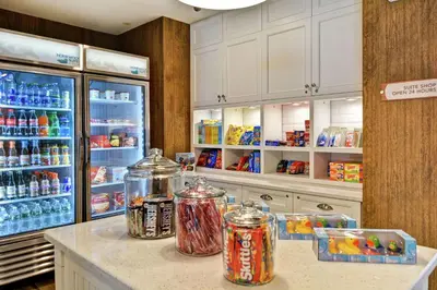 a kitchen with a refrigerator and jars of food at Homewood Suites By Hilton Hadley Amherst in Hadley