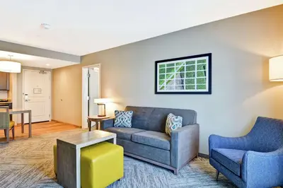 a living room with a couch and two chairs at Homewood Suites By Hilton Hadley Amherst in Hadley