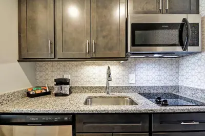 a kitchen with a sink and a microwave at Homewood Suites By Hilton Hadley Amherst in Hadley