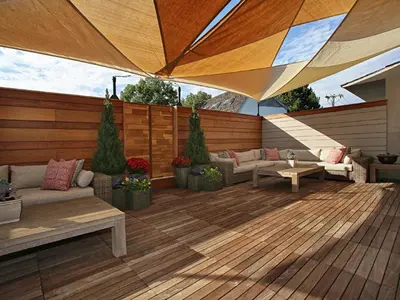 an outdoor patio with furniture and a large umbrella at The J House Greenwich Hotel in Greenwich