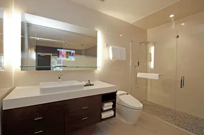 a bathroom with a sink and a toilet and a mirror at The J House Greenwich Hotel in Greenwich
