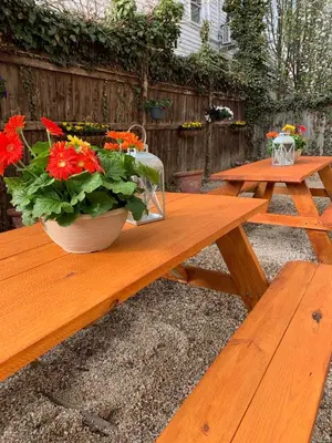 a wooden picnic table with a pot of flowers on it at Nest Hudson in Hudson