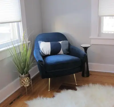 a blue chair with a pillow in a living room at Nest Hudson in Hudson