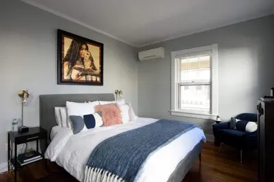 a bedroom with a bed and a painting on the wall at Nest Hudson in Hudson