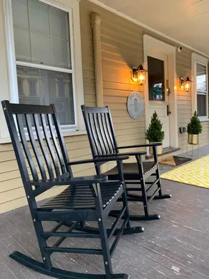two chairs sitting on the porch of a house at Nest Hudson in Hudson