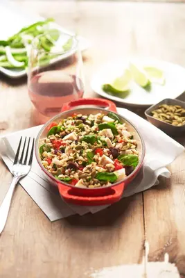 a red bowl of food on a wooden table at Hyatt Place New York/Midtown-South in New York