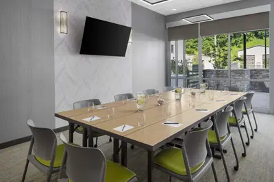 a conference room with a large wooden table and chairs at SpringHill Suites by Marriott Tuckahoe Westchester County in Tuckahoe