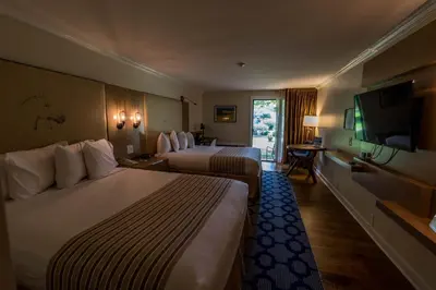 a hotel room with two beds and a flat screen tv at Interlaken Inn in Lakeville