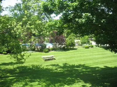 a park with a bench in the middle of a field at Interlaken Inn in Lakeville