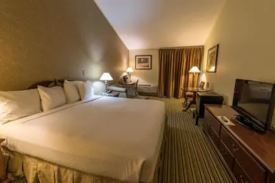 a hotel room with a bed and a flat screen tv at Interlaken Inn in Lakeville