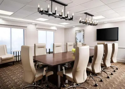 a conference room with a wooden table and chairs at Homewood Suites by Hilton Carle Place - Garden City, NY in Carle Place