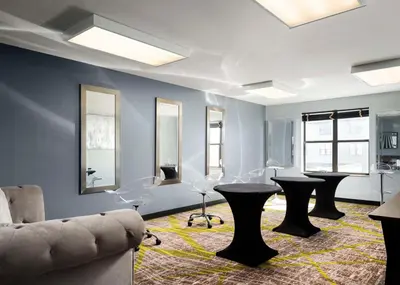 a living room with two tables and a couch at Homewood Suites by Hilton Carle Place - Garden City, NY in Carle Place