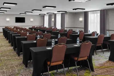 a conference room with rows of tables and chairs at Homewood Suites by Hilton Carle Place - Garden City, NY in Carle Place