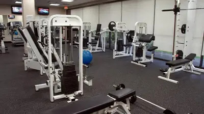 a gym with a lot of tread machines at The Armon Stamford Hotel & Conference Center in Stamford