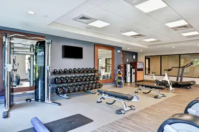 a gym with dumbbells and weights in a room at Homewood Suites By Hilton Poughkeepsie in Poughkeepsie