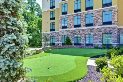 an image of a golf course in front of a building at Homewood Suites By Hilton Poughkeepsie in Poughkeepsie