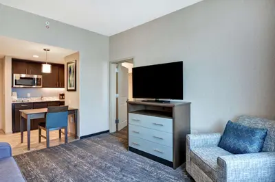 a living room with a flat screen tv and a couch at Homewood Suites By Hilton Poughkeepsie in Poughkeepsie