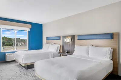 a hotel room with two beds and a window at Holiday Inn Express Hartford-Newington by IHG in Newington