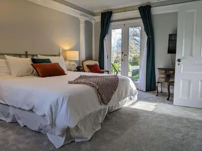 a bedroom with a large bed and a window at Stanton House Inn in Greenwich