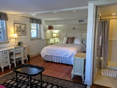 a bedroom with a bed and a desk and a chair at Stanton House Inn in Greenwich