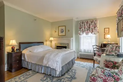 a bedroom with a bed and a fireplace at Stanton House Inn in Greenwich