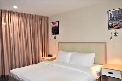 a hotel room with a bed and a window at LIC Plaza Hotel in Queens