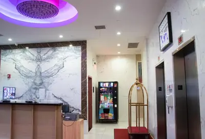 a lobby with a vending machine and a purple ceiling at LIC Plaza Hotel in Queens