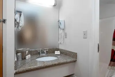 a bathroom with a sink and a phone at Red Roof Inn Clifton Park in Clifton Park