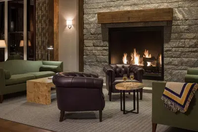 a living room with couches and a fireplace at The Williams Inn in Williamstown