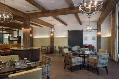 a restaurant with tables and chairs and a bar at The Williams Inn in Williamstown