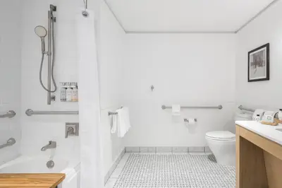 a white bathroom with a tub and a toilet at The Williams Inn in Williamstown