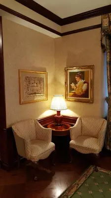 a room with two chairs and a table with a lamp at The Wall Street Inn in New York