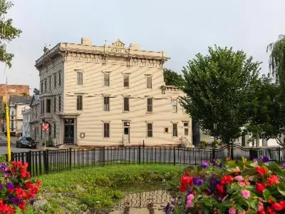 a large white building with flowers in front of it at Stewart House Hotel in Athens
