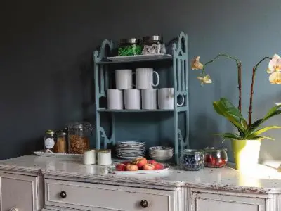 a table with a shelf with cups and fruit on it at Stewart House Hotel in Athens