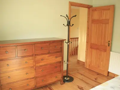 a bedroom with a dresser and a bed and a closet at Stewart House Hotel in Athens