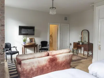 a living room with a couch and a table at Stewart House Hotel in Athens