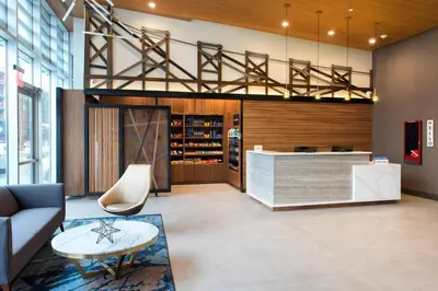 a lobby of a wine store with a couch and a table at TownePlace Suites by Marriott New York Long Island City in Queens